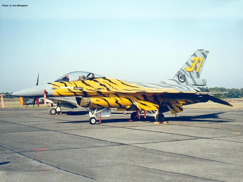 tiger-striped fighter jet on tarmac