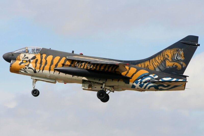 Tiger-themed military jet in flight