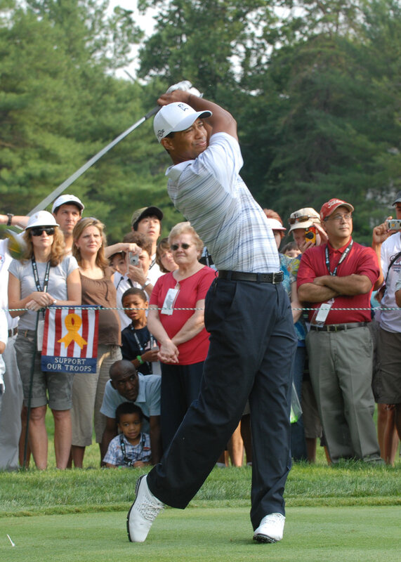 Tiger Woods swings on golf course