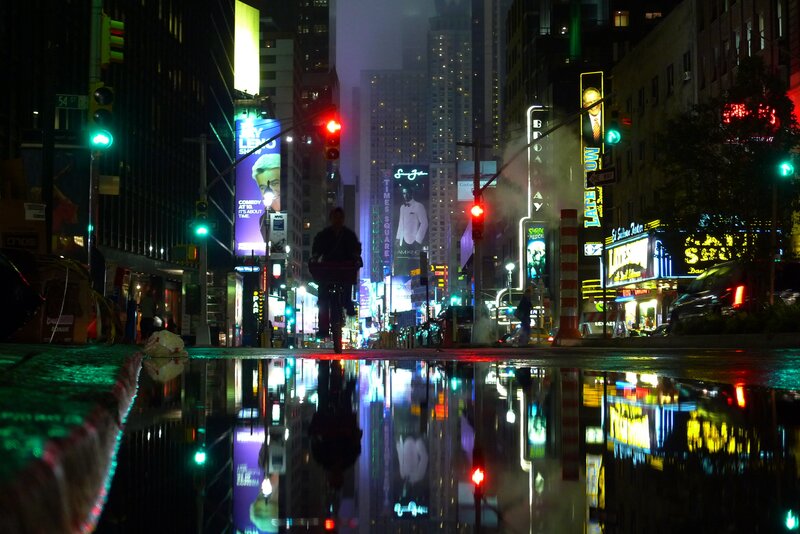 Times Square at night with reflections