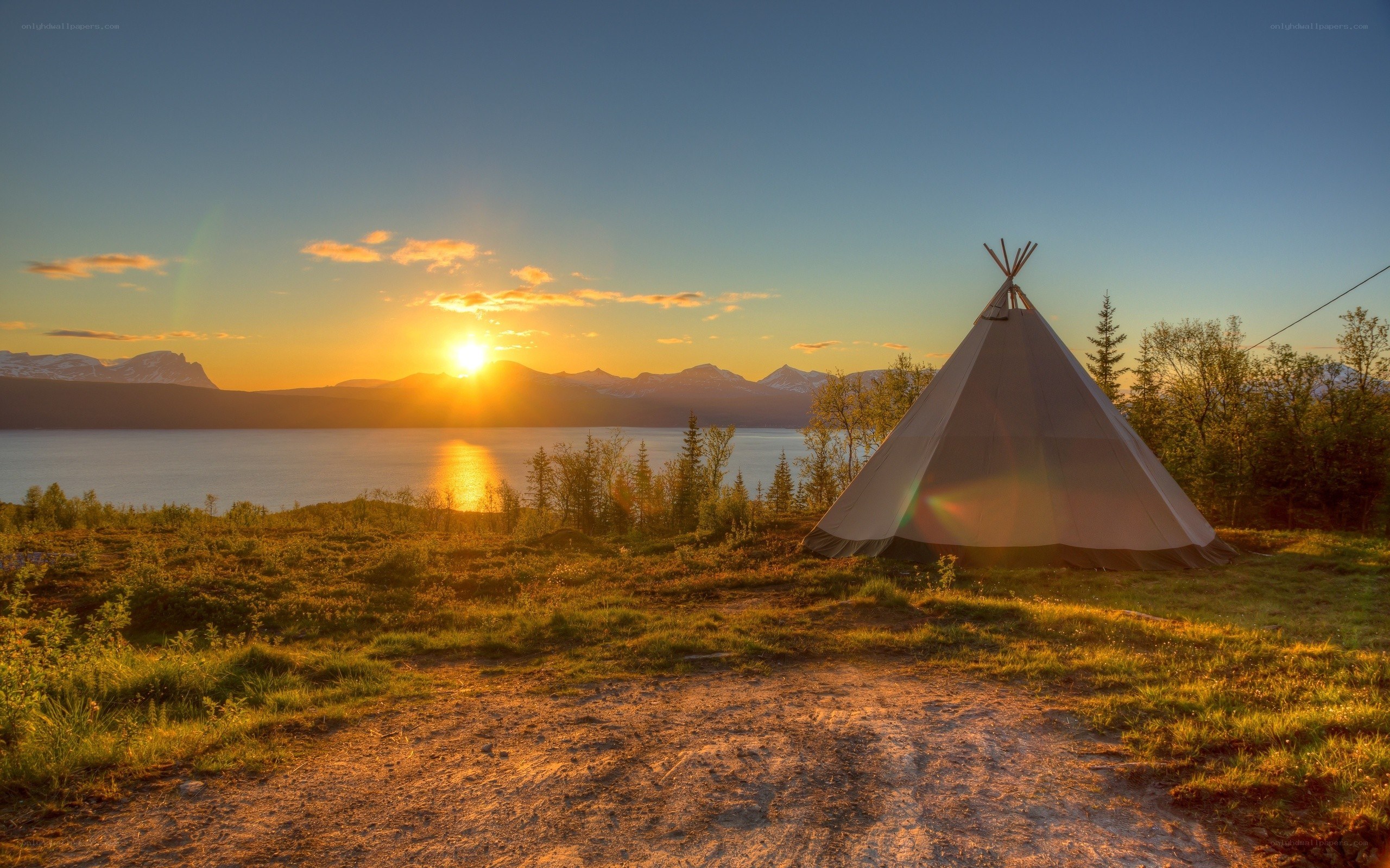 Tipi tent at sunset by a lake