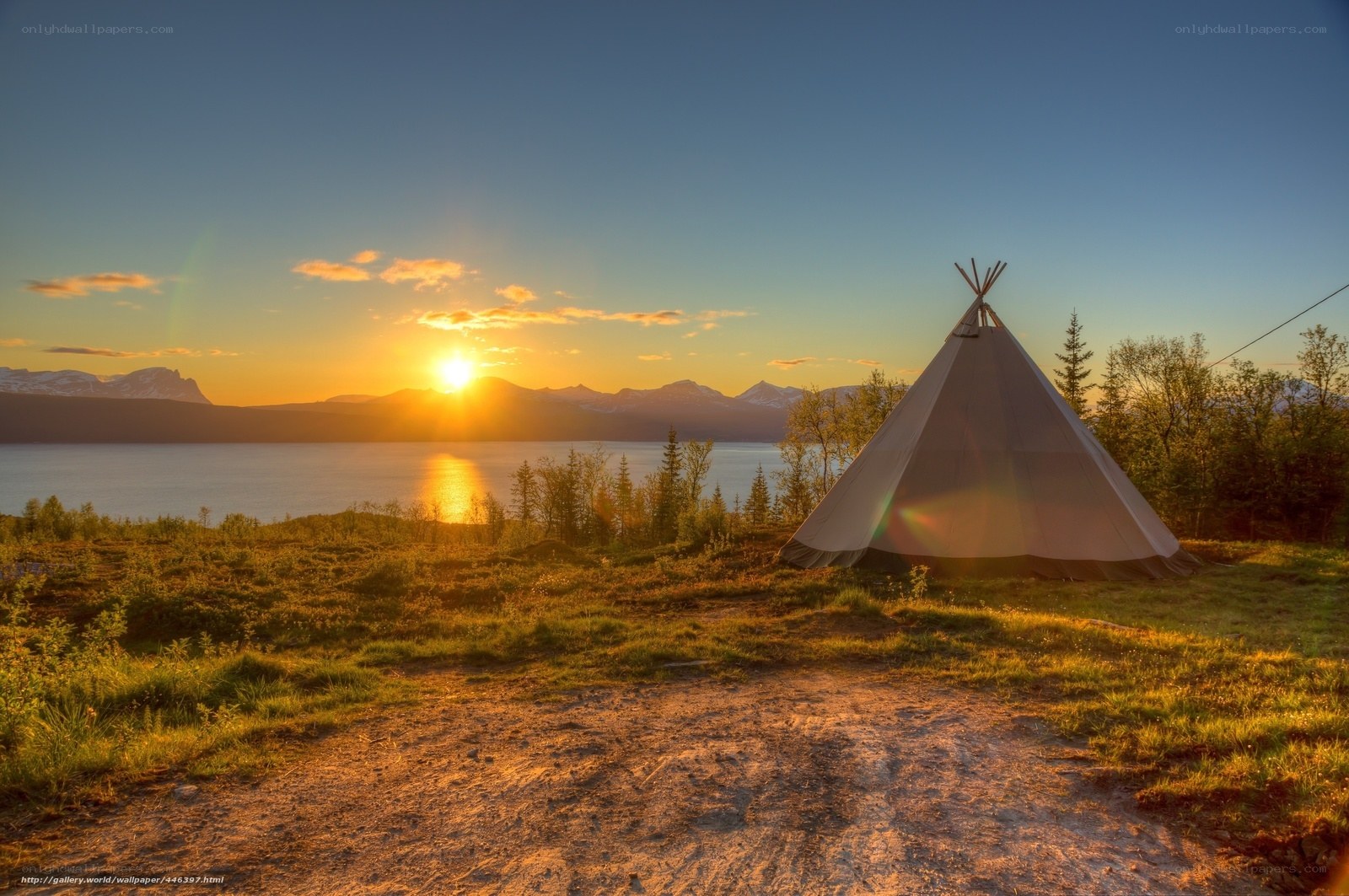 Tipi tent at sunset by lake