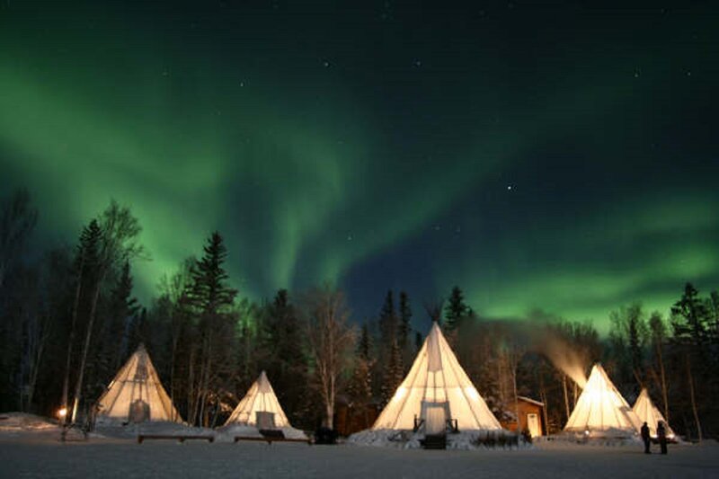 Tipis under Aurora Borealis