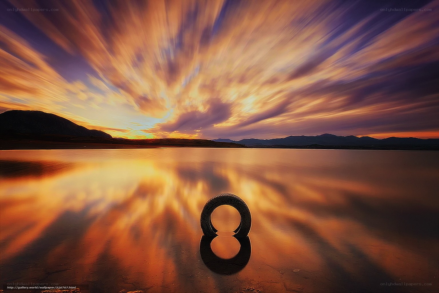 Tire on a reflective lake