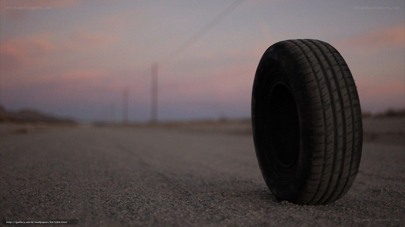 tire on empty road at dusk
