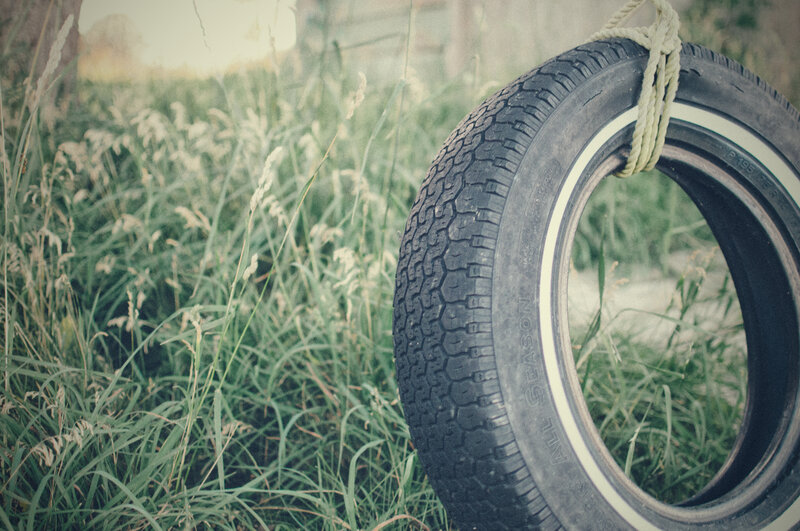 tire swing in tall grass