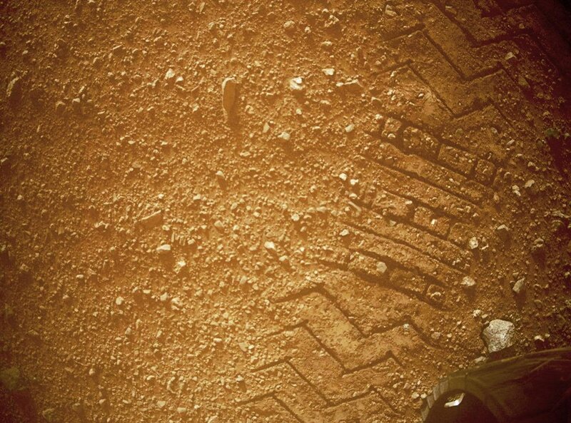 tire tracks on dusty ground