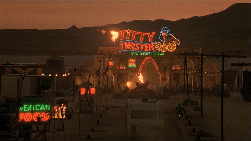 Titty Twister neon sign at dusk
