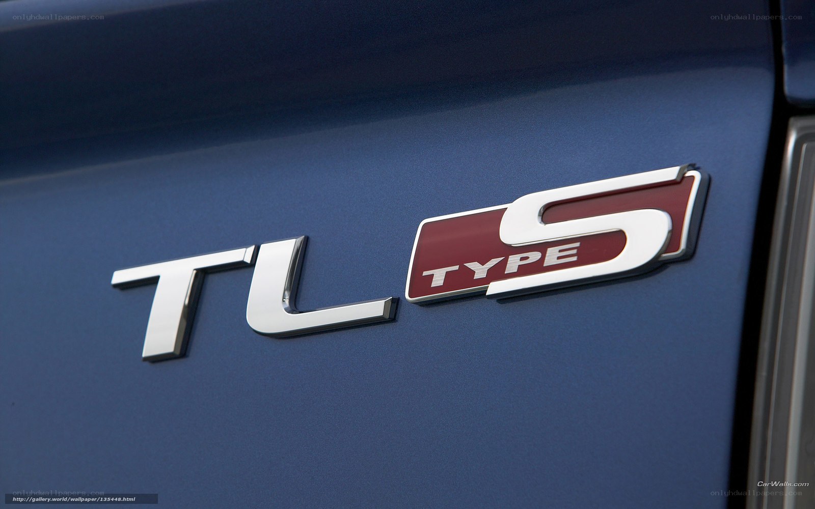 TL S Type badge on blue car