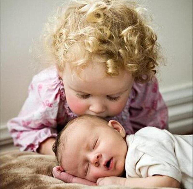 Toddler Kissing Baby