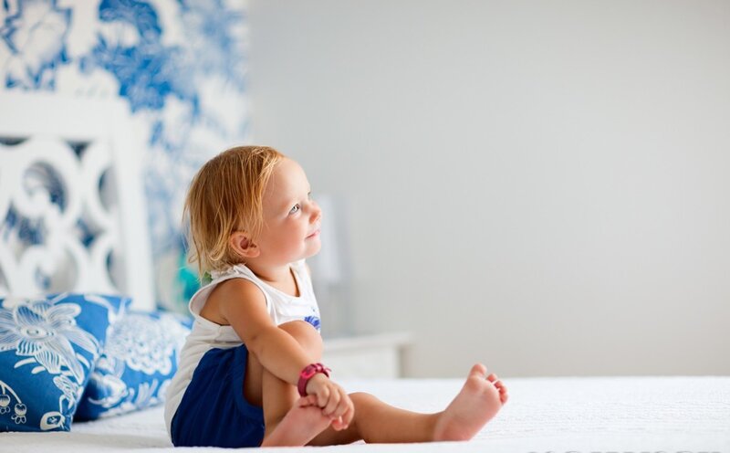 Toddler Sitting on Bed