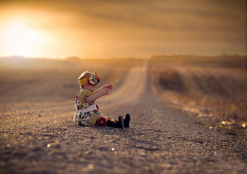 Toddler Sitting on Road