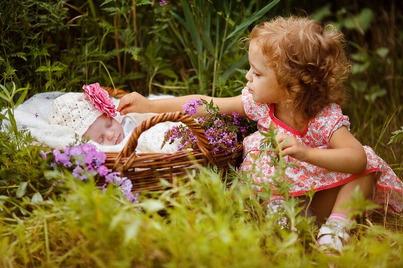 Toddler with Baby in Basket