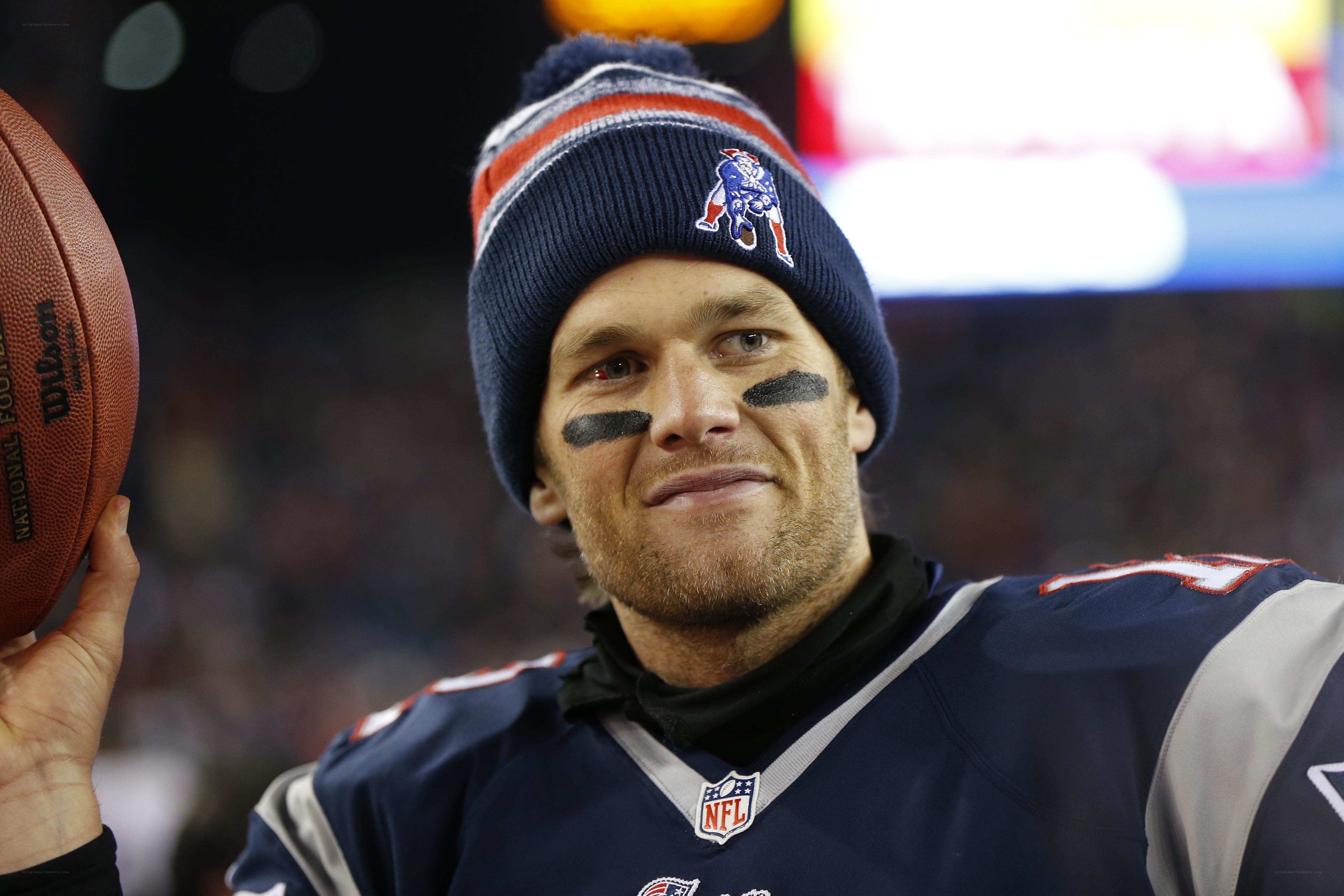 Tom Brady holding football