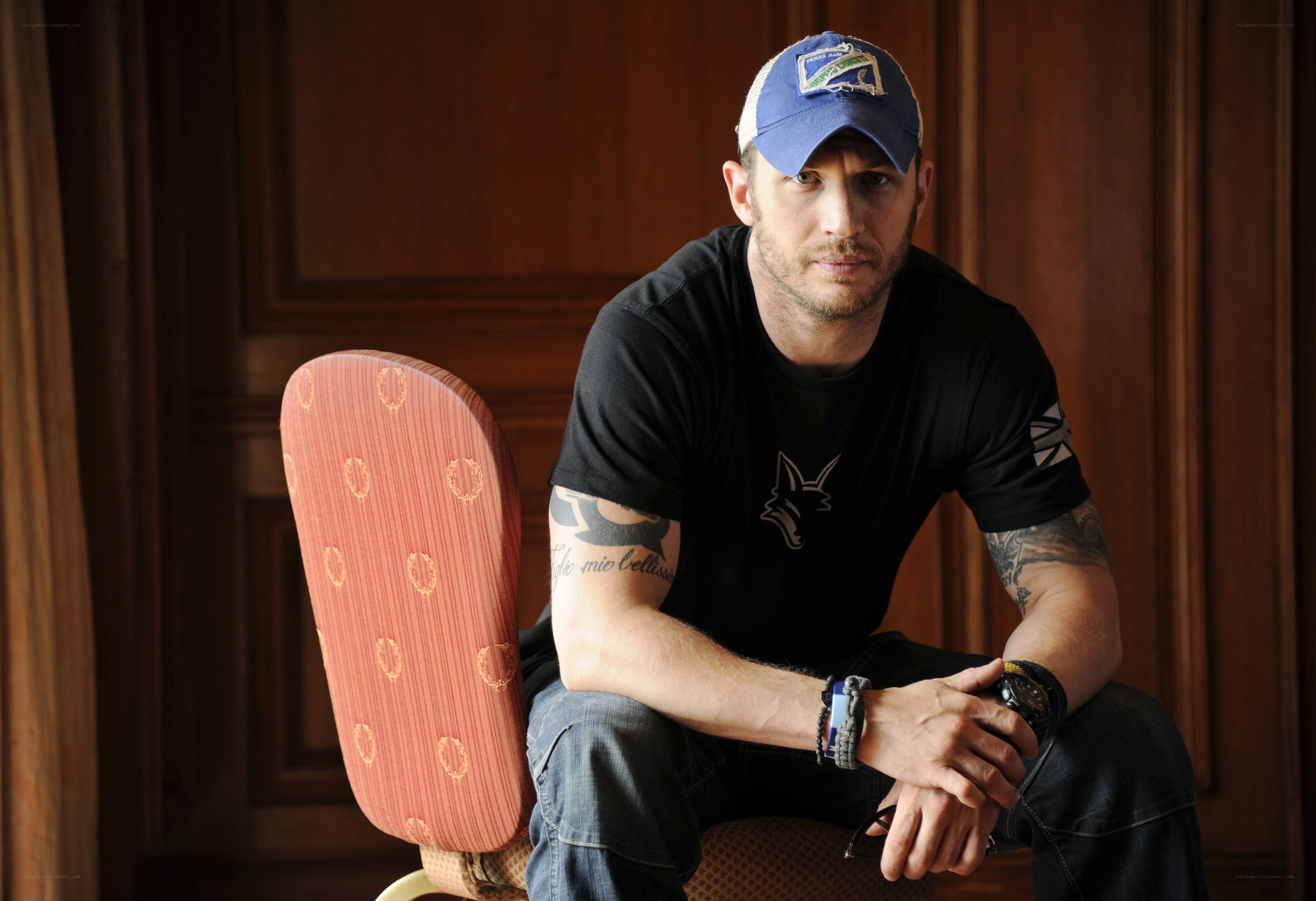 Tom Hardy sitting in a chair