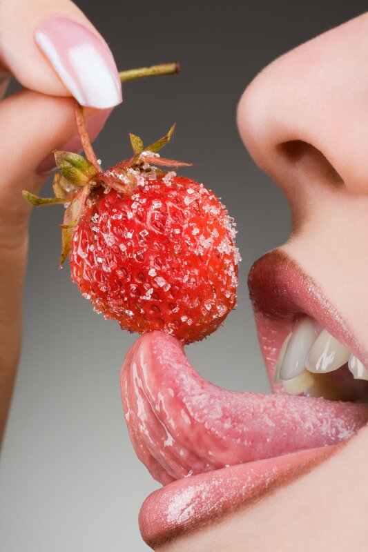 tongue licking a strawberry