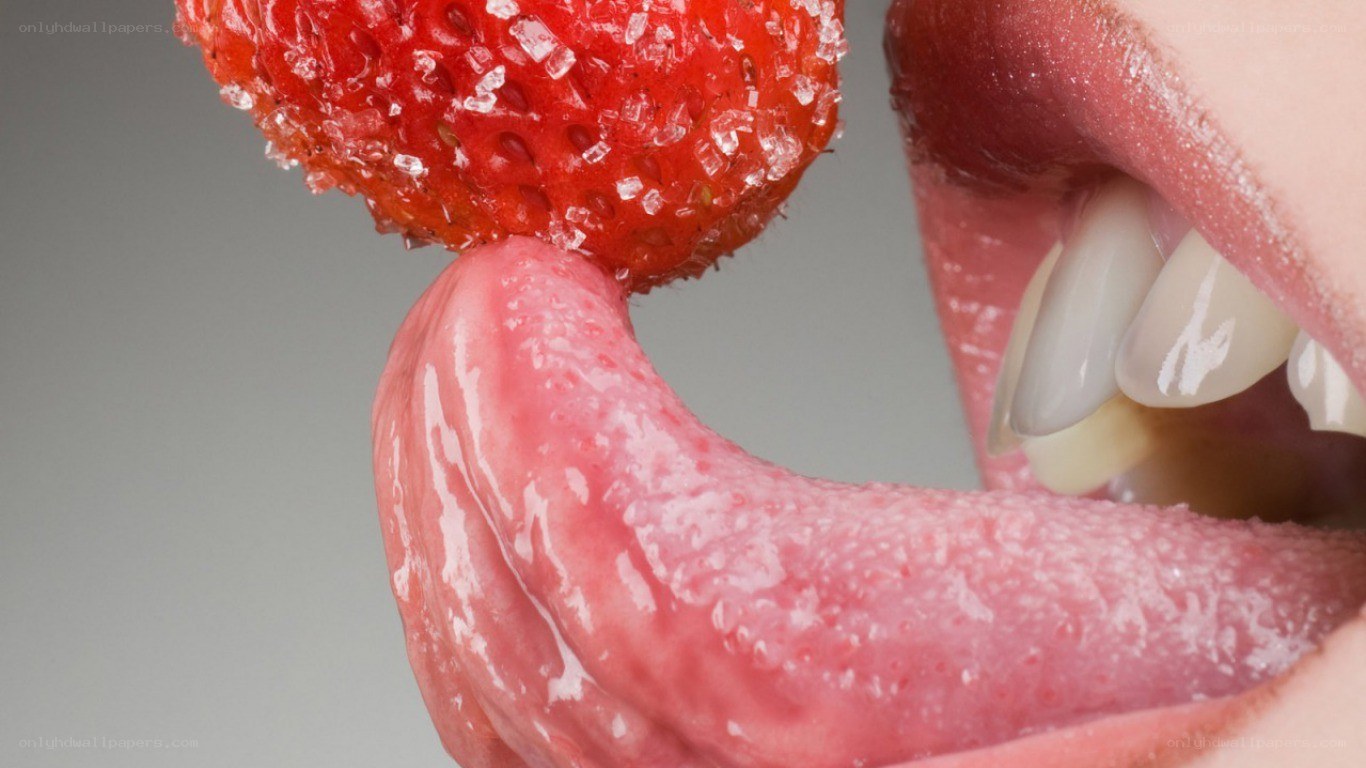 tongue licking a strawberry