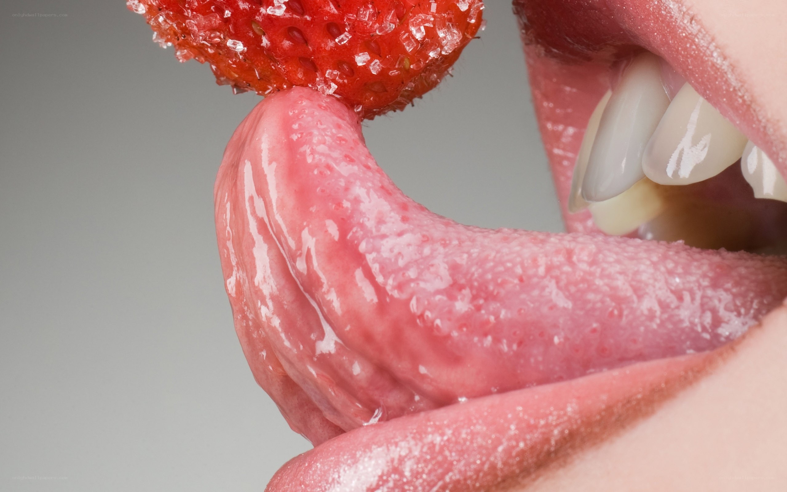 tongue licking a strawberry