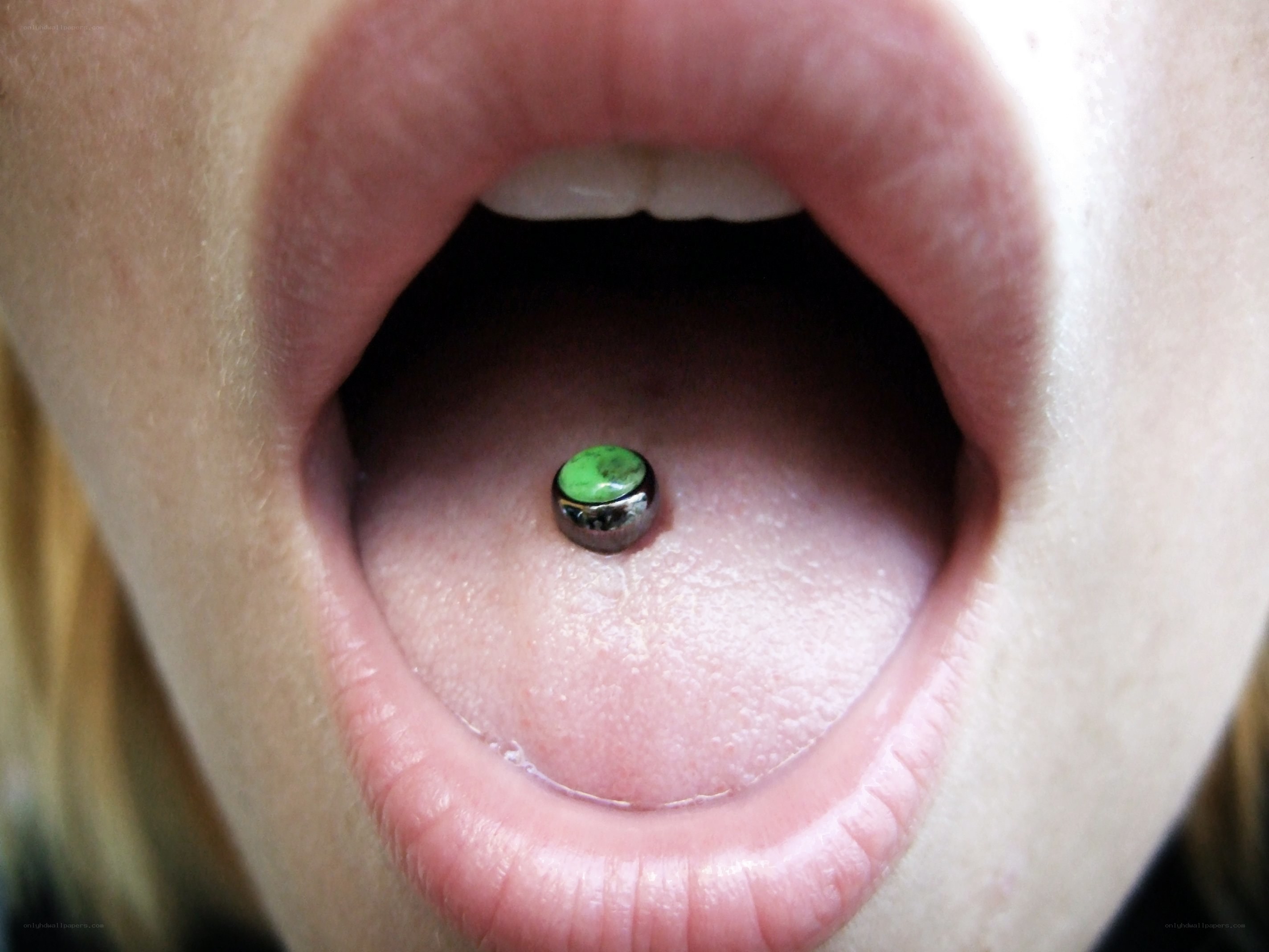 tongue piercing with green gem
