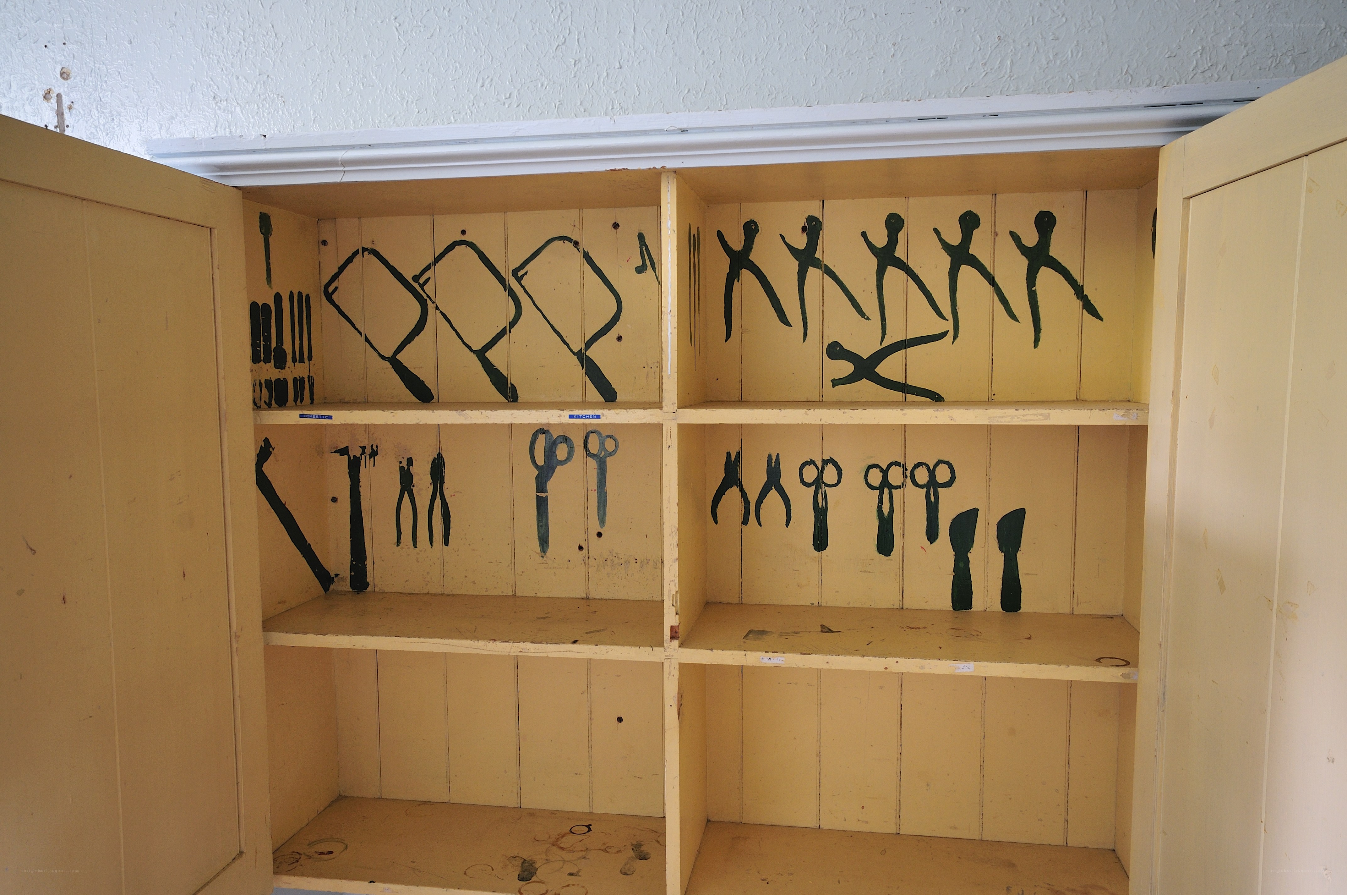 Tool cabinet with painted silhouettes