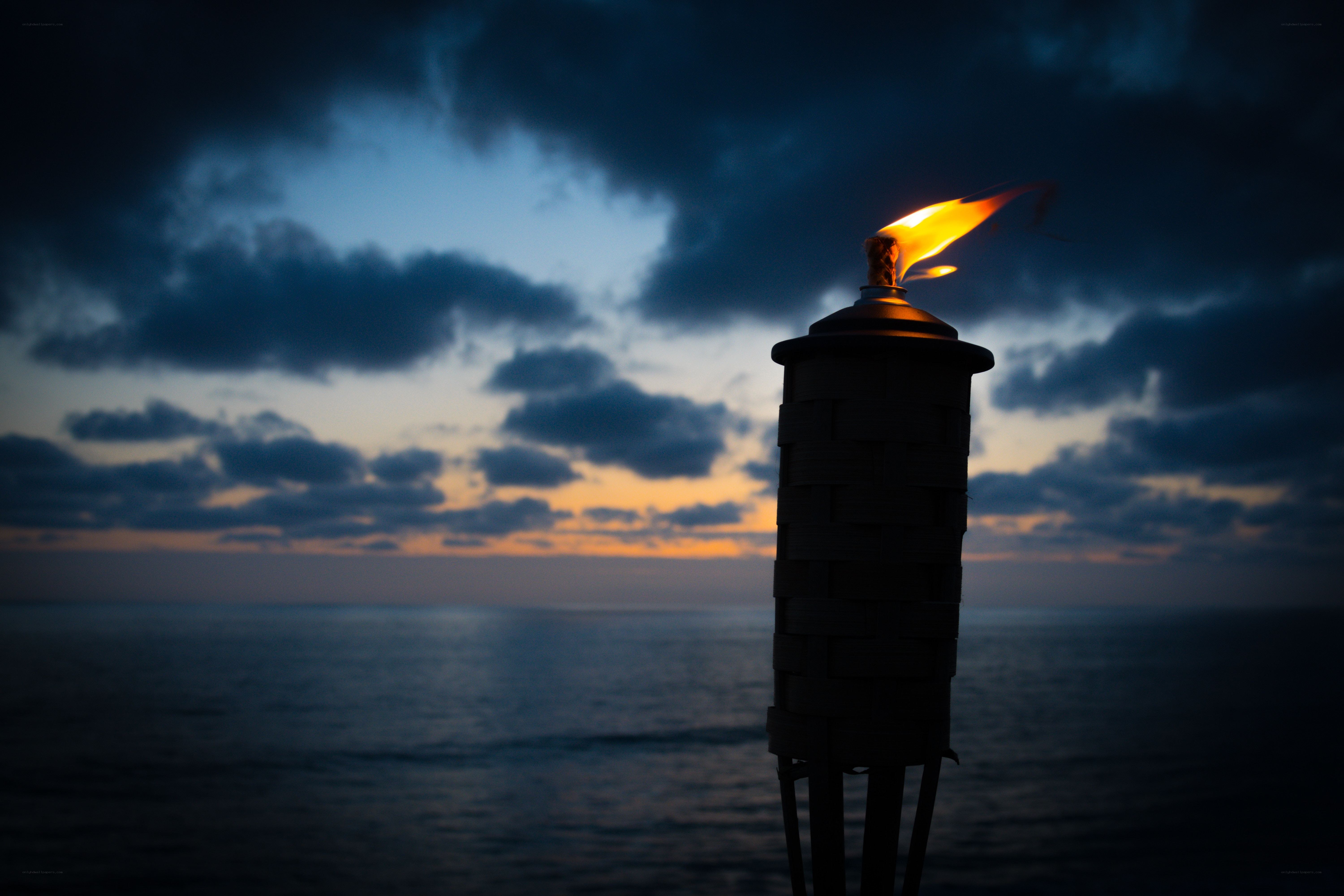 Torch at dusk by the sea