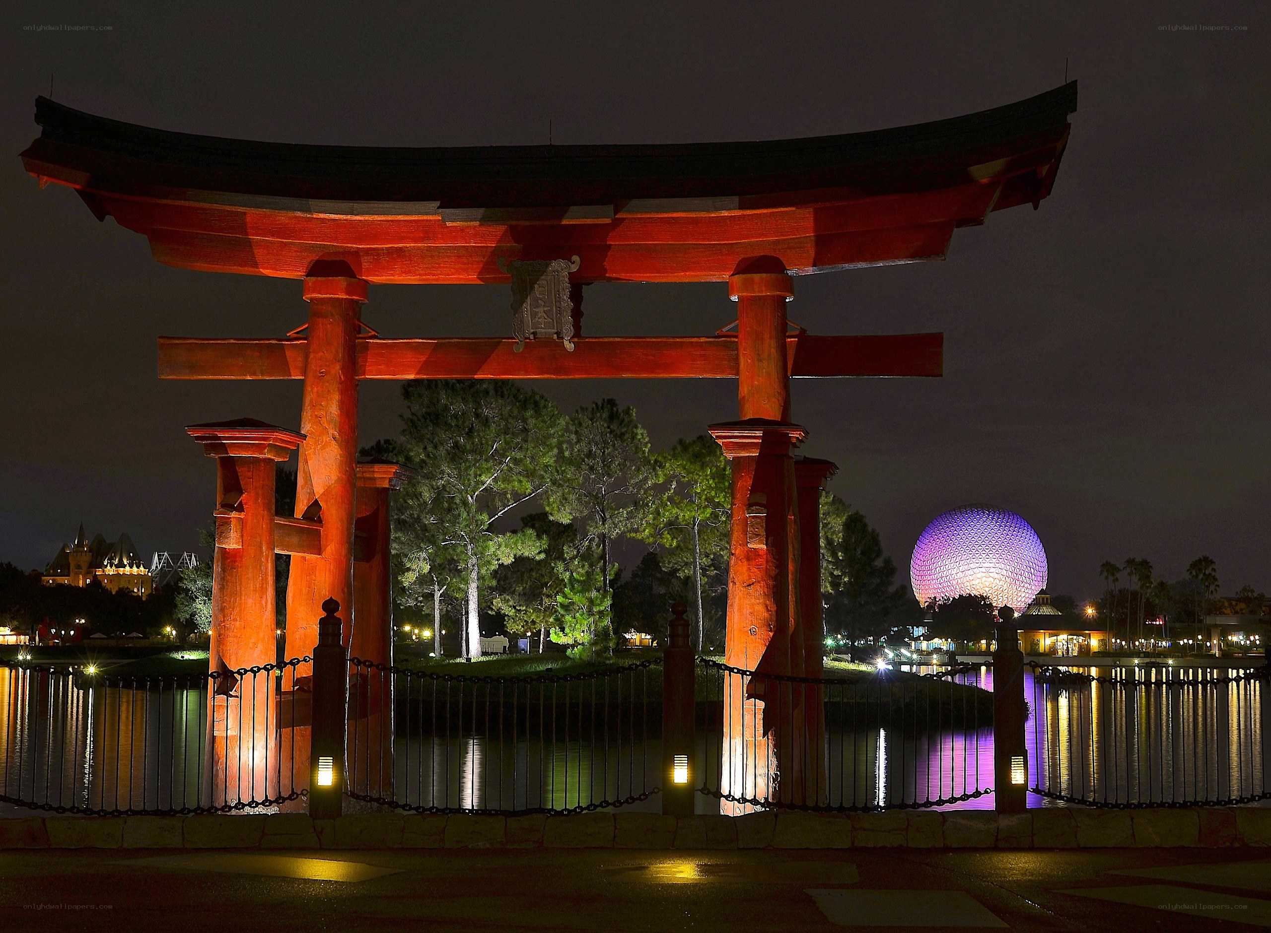 Torii gate at night with Epcot sphere