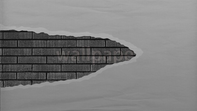 torn paper revealing brick wall