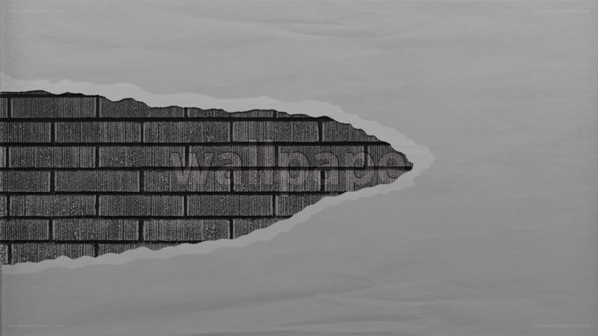 torn paper revealing brick wall