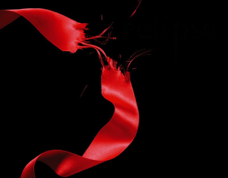 Torn red ribbon on black