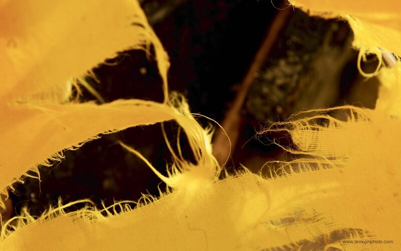 torn yellow fabric close-up