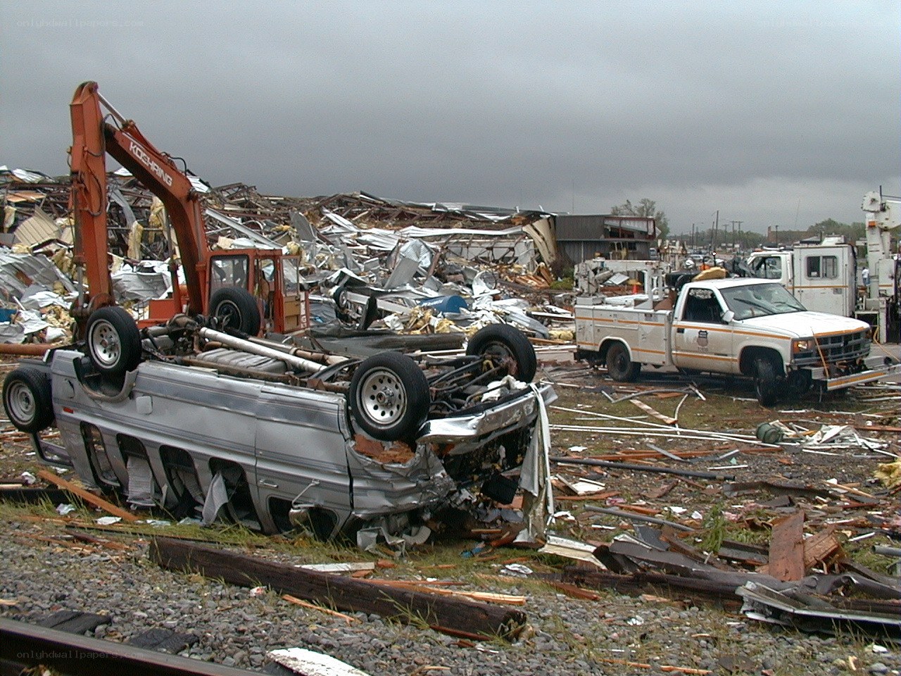 Tornado aftermath with damaged vehicles