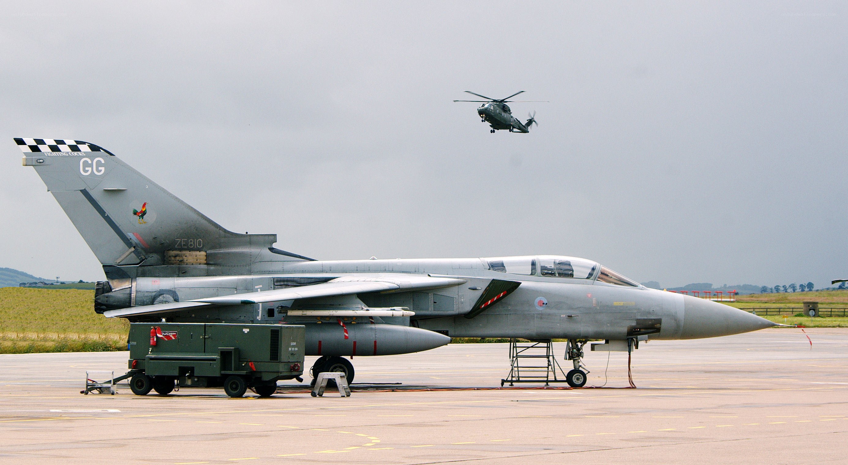 Tornado jet on airfield with helicopter