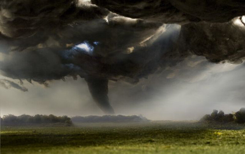 Tornado over a green field