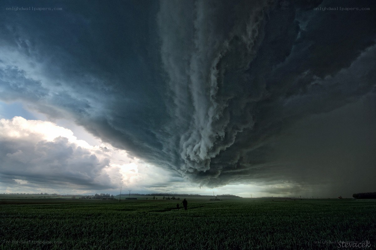 Tornado over a green field