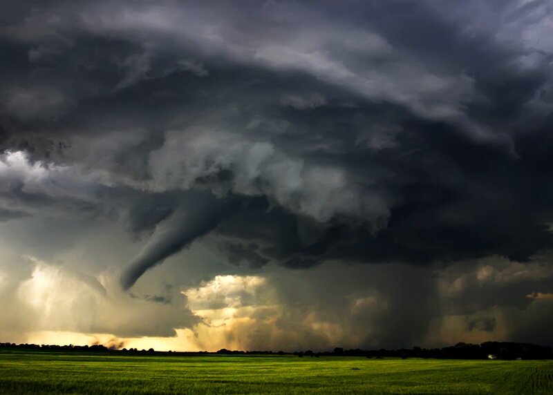 Tornado over a green field