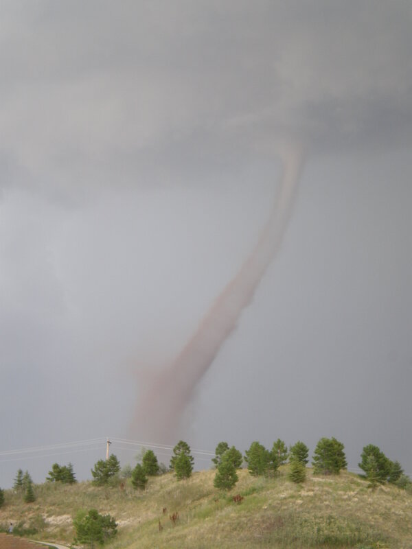 Tornado over a hillside