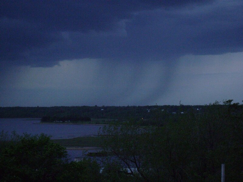 Tornado over a lake at dusk