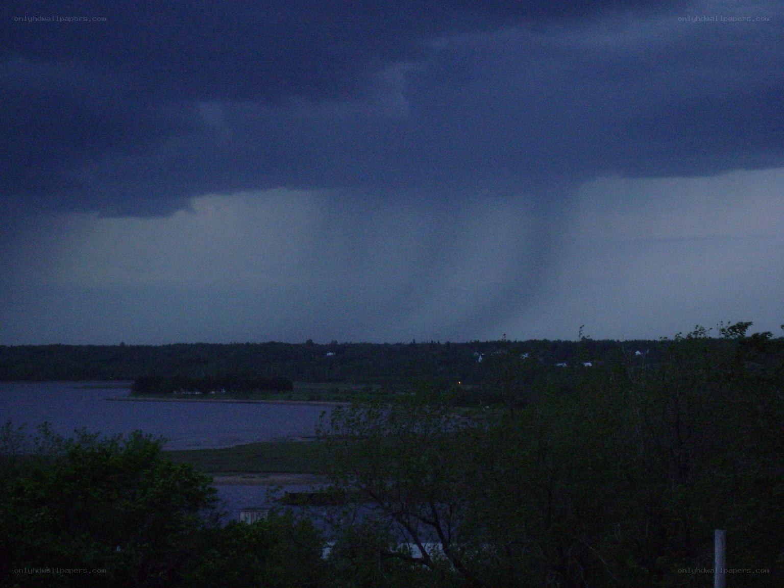 Tornado over a lake at dusk