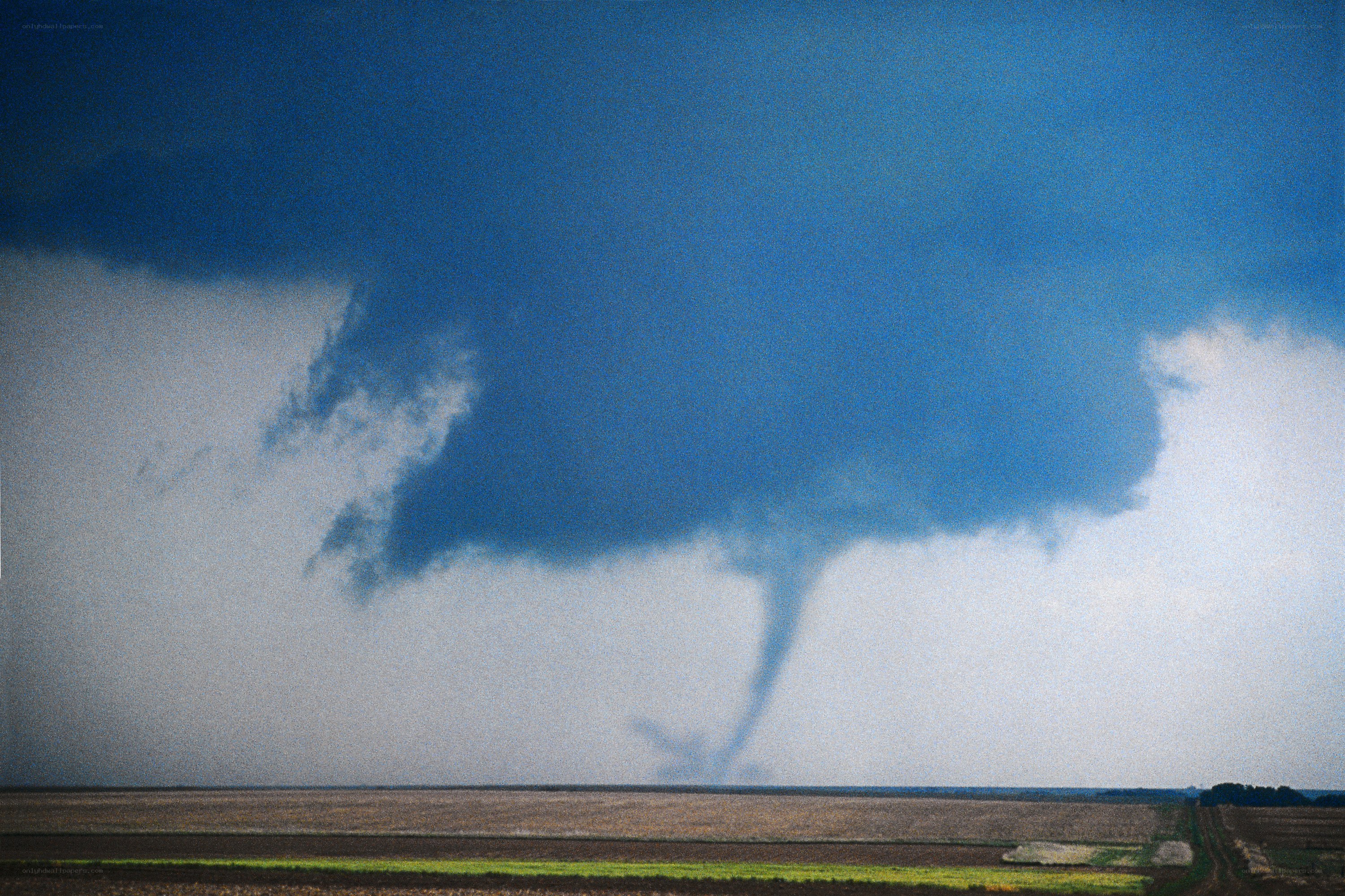 Tornado over a rural field