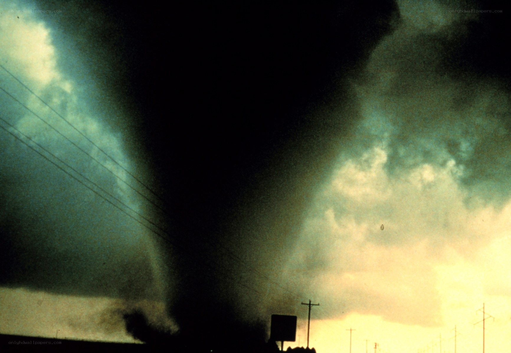 Tornado over a rural landscape