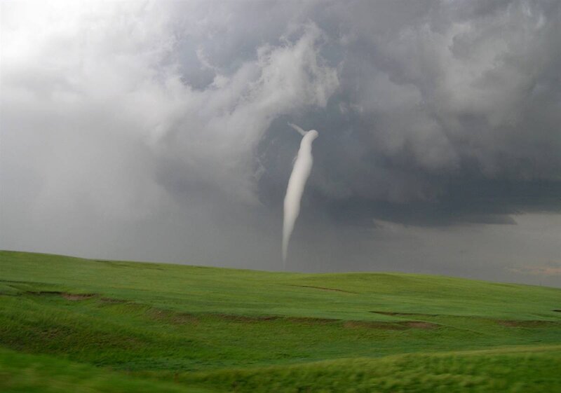 Tornado over green fields