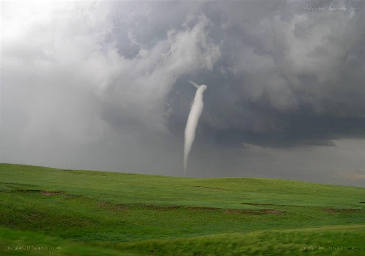 Tornado over green fields