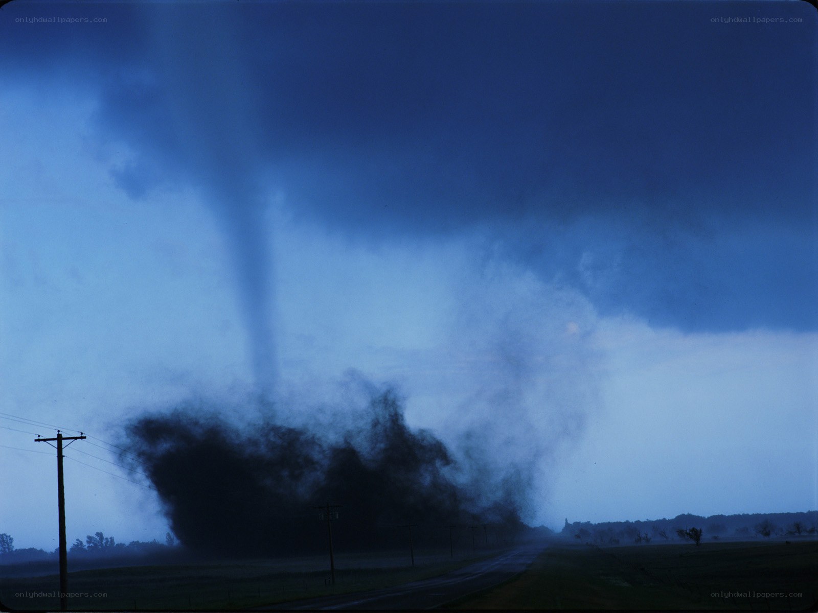 Tornado over rural landscape