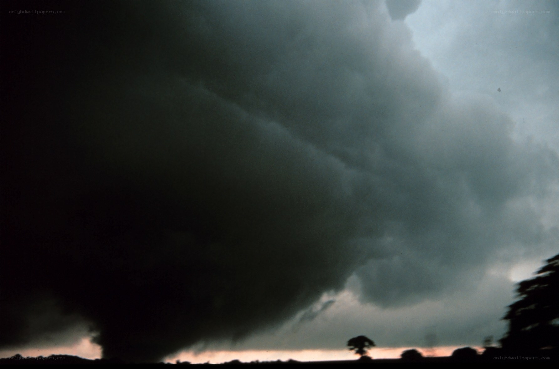 Tornado over rural landscape