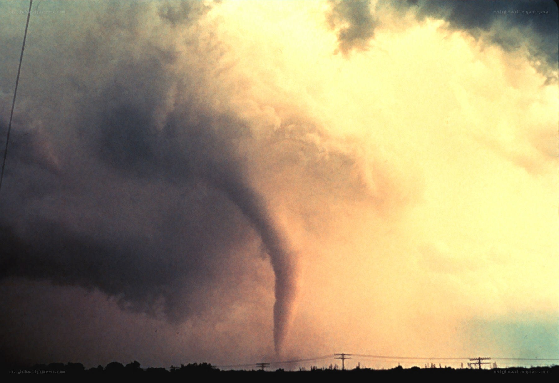 Tornado over rural landscape