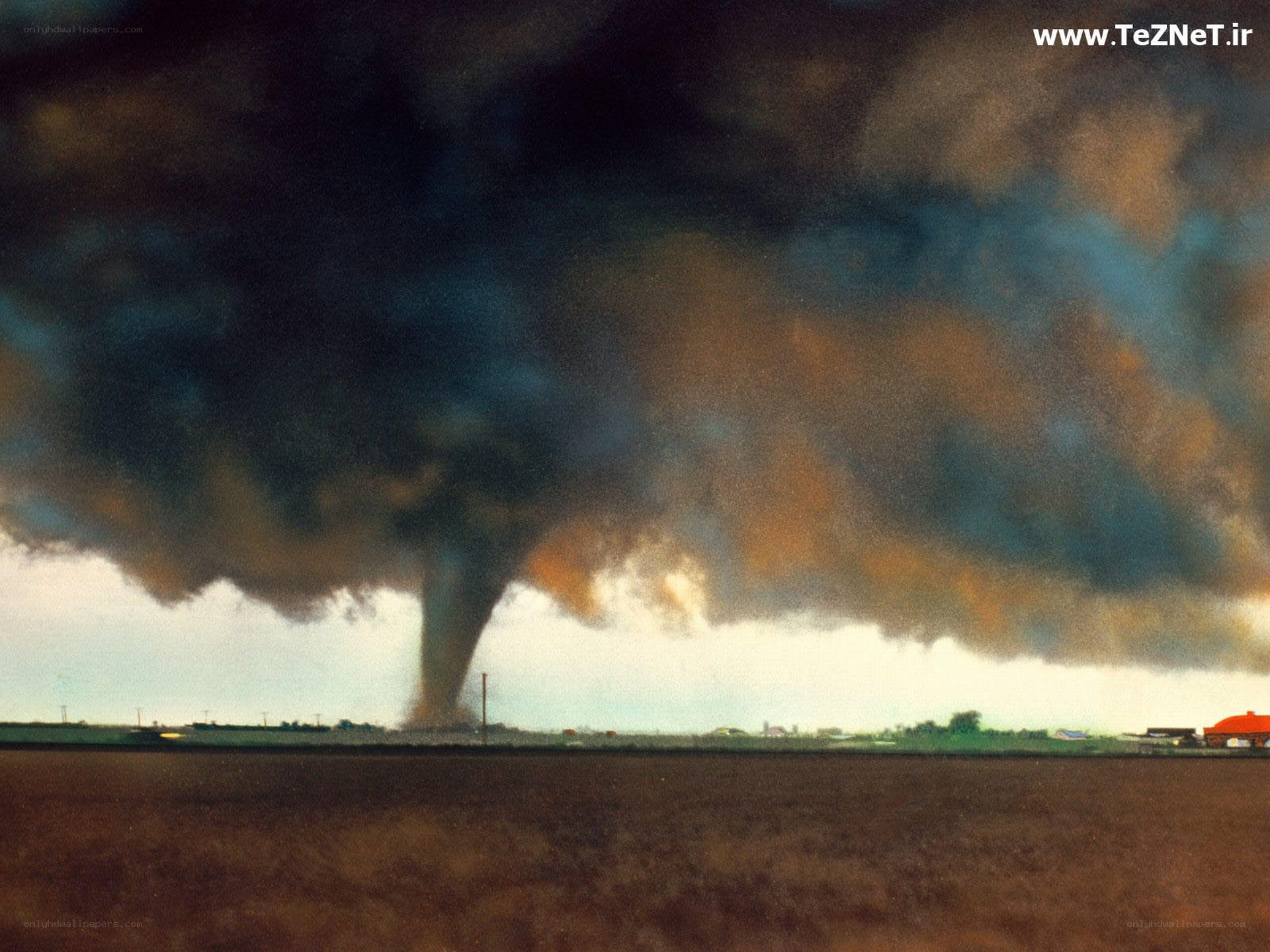 Tornado over rural landscape