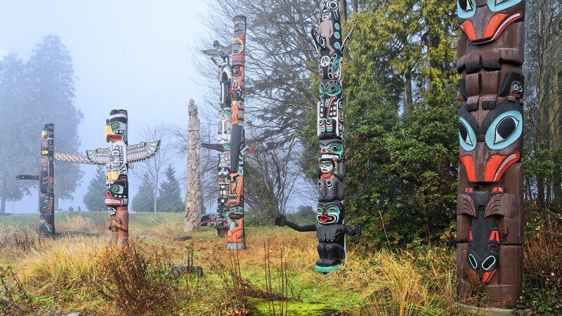 Totem poles in a foggy forest
