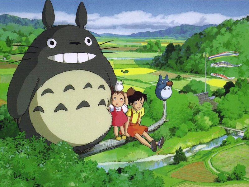 Totoro and children in a green landscape