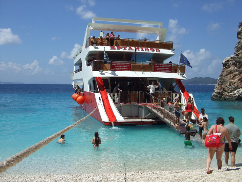 Tour boat at beach with swimmers