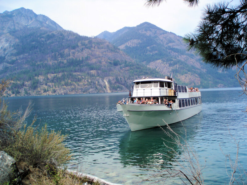 Tour boat on a lake with mountains